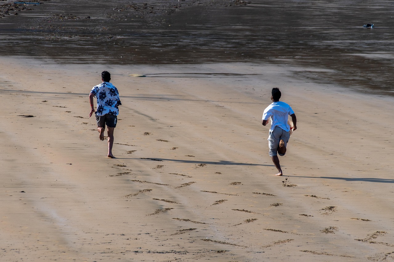 image of men chasing each other on a beach